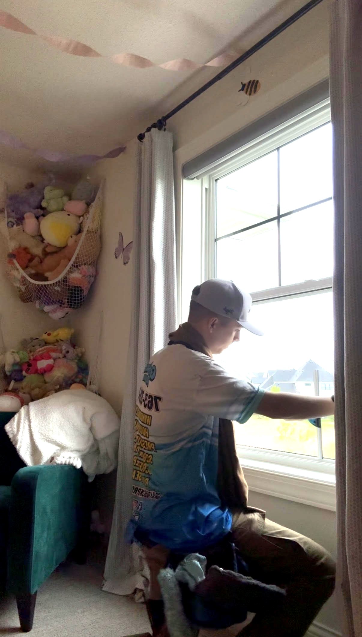 Gray Duck Pro Wash owner hand-cleaning interior windows inside a Rosemount MN home